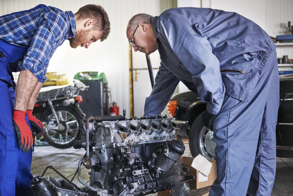 mechanics repairing car workshop 1